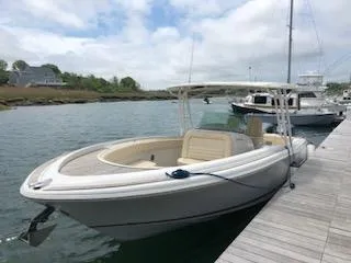 Slide: The Image of 2013 Chris-Craft Catalina 29 Sun Tender docked by the water. - 2