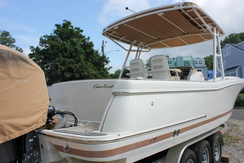 Slide: The Image of 2013 Chris-Craft Catalina 29 Sun Tender boat on trailer, featuring sleek design and canopy. - 22