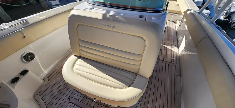 Slide: The Image of 2013 Chris-Craft Catalina 29 Sun Tender with beige leather seating and teak flooring. - 6