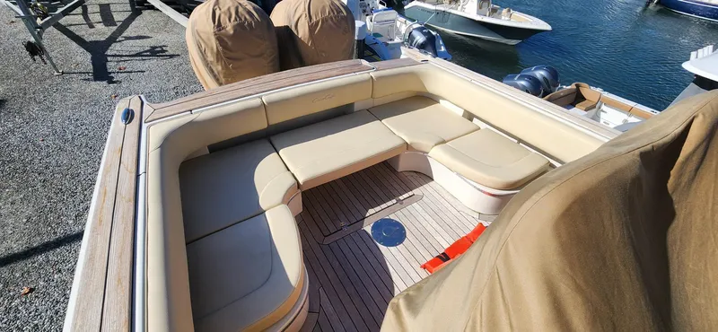 Slide: The Image of 2013 Chris-Craft Catalina 29 Sun Tender with spacious seating, docked by the water. - 7