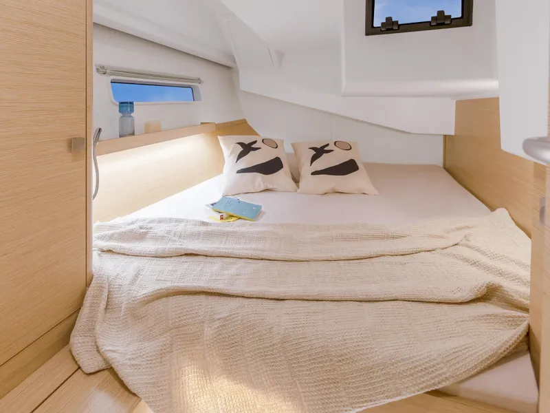 Slide: The Image of Cozy bedroom in 2025 Hanse 410 yacht with modern design and natural light. - 23
