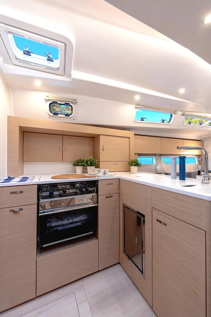 Slide: The Image of Modern Hanse 360 sailboat deck with seating and table, 2025 model, on open water. - 25