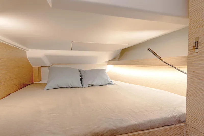Slide: The Image of Cozy cabin interior of 2025 Hanse 360 yacht with bed and soft lighting. - 28