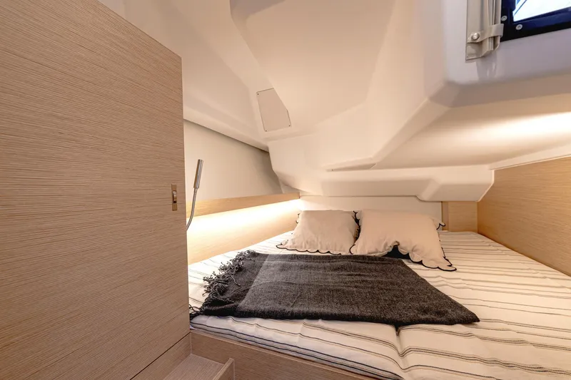 Slide: The Image of Cozy cabin interior of 2025 Hanse 360 yacht with bed and soft lighting. - 26