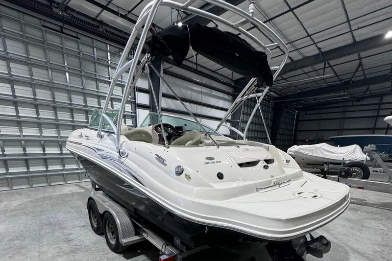 Slide: The Image of 2005 Sea Ray 220 Sundeck boat on trailer in storage facility. - 2