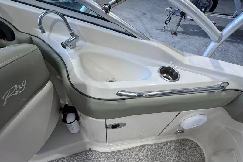 Slide: The Image of 2005 Sea Ray 220 Sundeck interior with sink and storage area. - 3