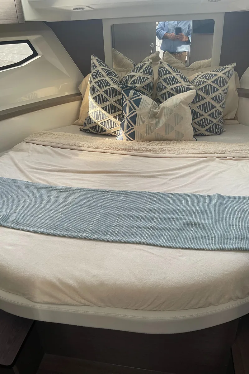 Slide: The Image of Luxurious cabin interior of 2025 Jeanneau NC 895 Series 2 with plush bedding. - 10