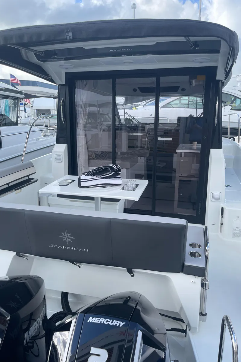 Slide: The Image of 2025 Jeanneau NC 895 Series 2 boat with Mercury engines, docked at marina. - 16