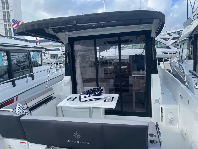 Slide: The Image of 2025 Jeanneau NC 895 Series 2 boat, rear view, docked at marina. - 3