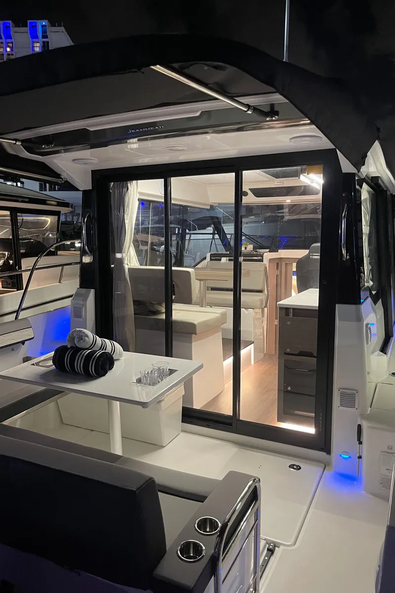 Slide: The Image of 2025 Jeanneau NC 895 Series 2 boat interior with modern design and ambient lighting. - 4