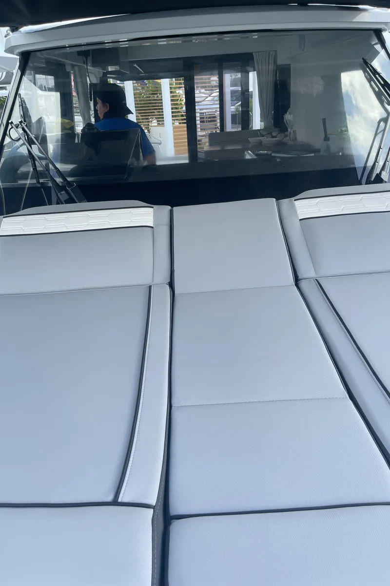 Slide: The Image of 2025 Jeanneau NC 895 Series 2 boat interior with cushioned seating. - 9