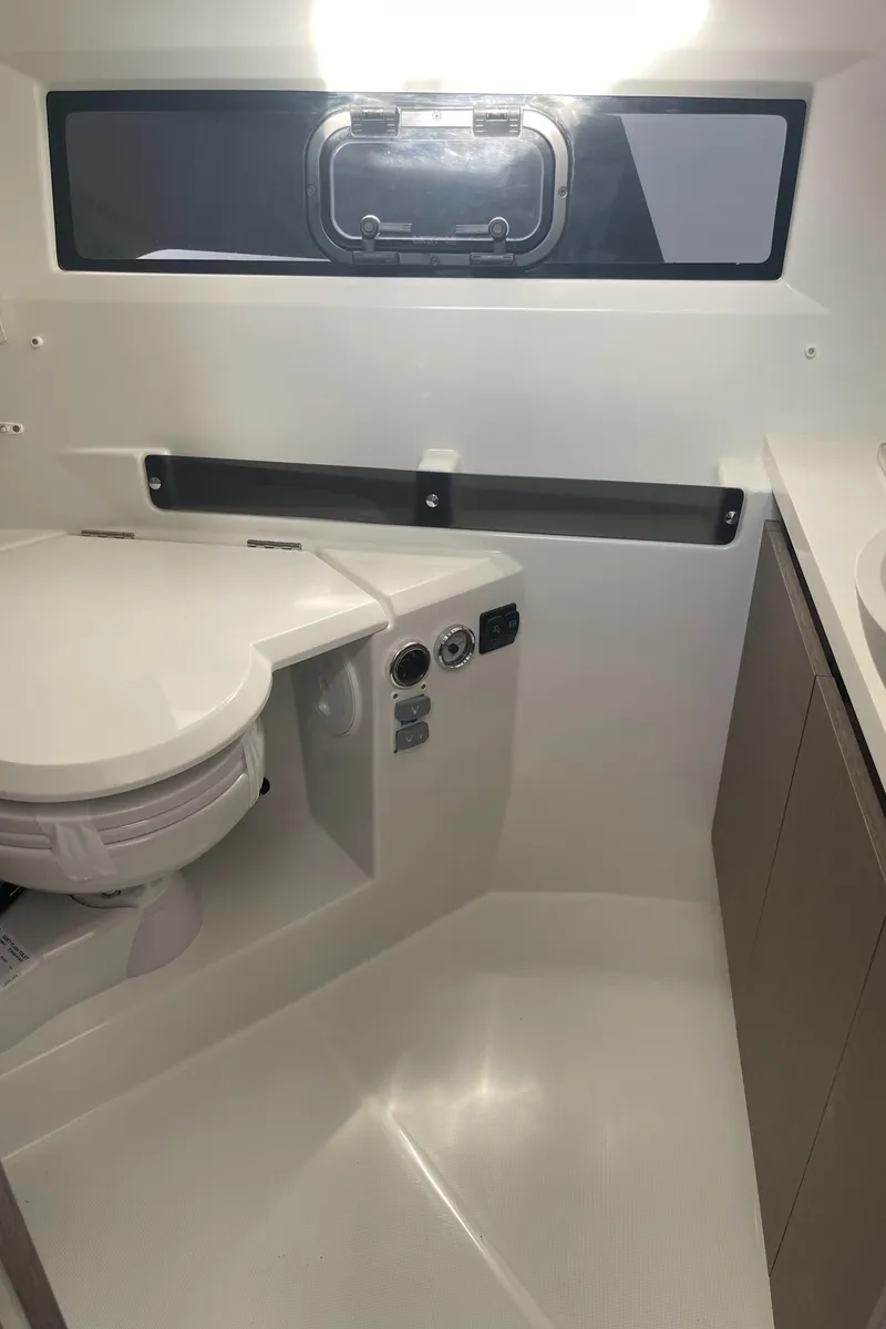 Slide: The Image of 2026 Jeanneau NC 895 Series 2 helm with modern controls and navigation display. - 12