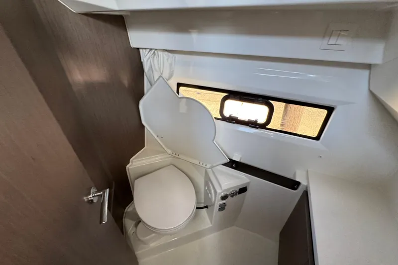 Slide: The Image of 2026 Jeanneau NC 895 Series 2 boat bathroom with toilet and window. - 26