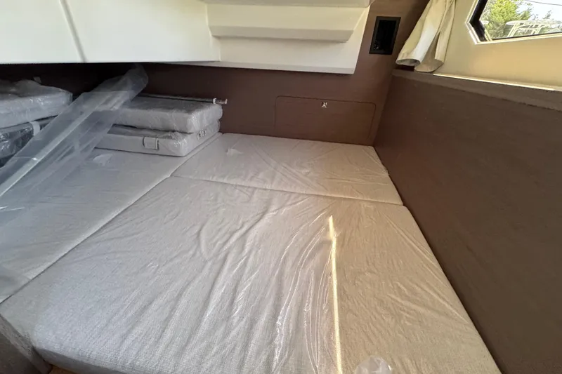 Slide: The Image of Interior cabin of 2026 Jeanneau NC 895 Series 2 with cushioned bedding. - 29