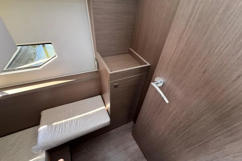 Slide: The Image of Interior of 2026 Jeanneau NC 895 Series 2, featuring modern wood finish and compact design. - 30