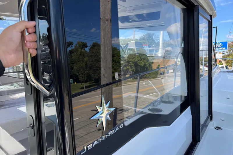 Slide: The Image of 2026 Jeanneau NC 895 Series 2 boat with sleek glass windows and chrome handle. - 33