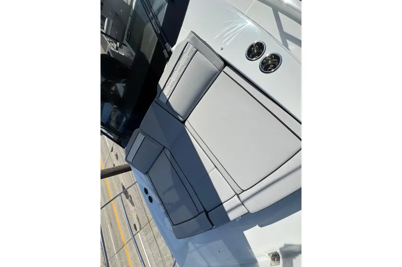 Slide: The Image of 2026 Jeanneau NC 895 Series 2 boat seating area with cup holders, showcasing modern design. - 40