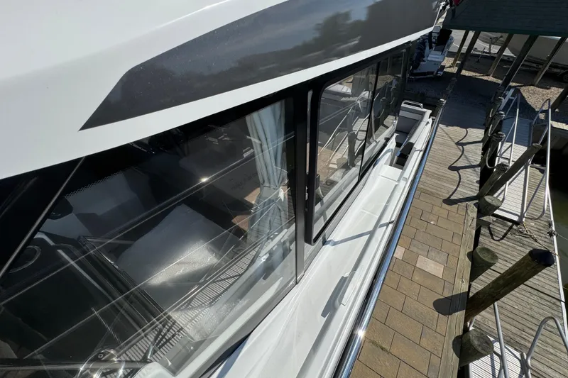 Slide: The Image of 2026 Jeanneau NC 895 Series 2 docked, showcasing sleek design and modern windows. - 42