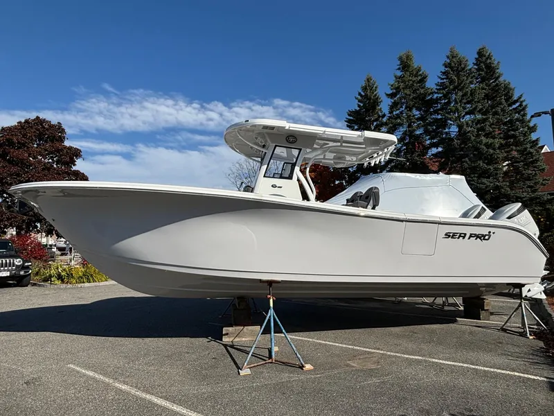 The Image of 2025 Sea Pro 292 DLX boat on display in a parking lot. - 0