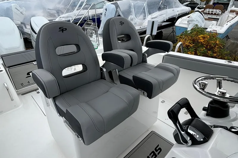 Slide: The Image of 2025 Sea Pro 292 DLX boat seats and helm, showcasing luxury and comfort. - 13