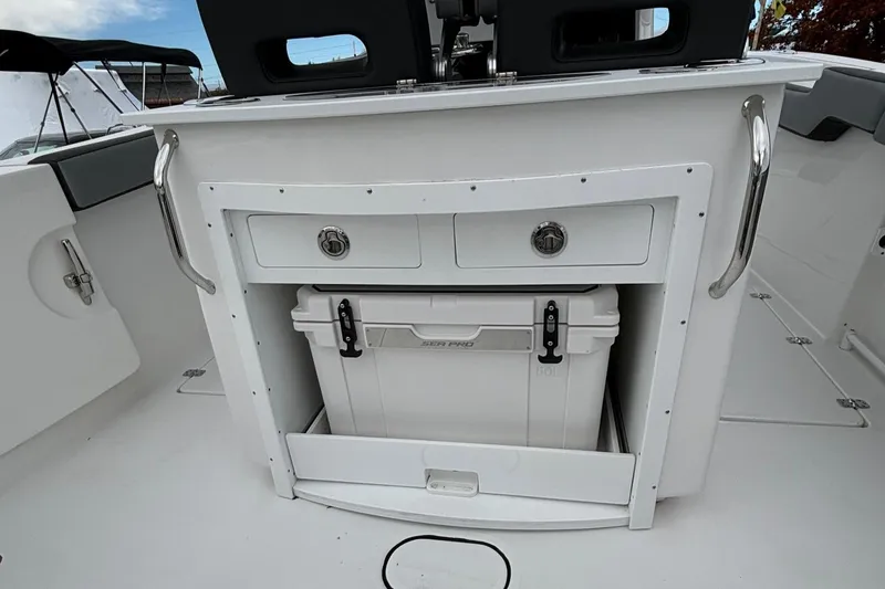 Slide: The Image of 2025 Sea Pro 292 DLX boat interior with storage compartment and cooler. - 15