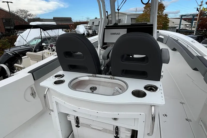Slide: The Image of 2025 Sea Pro 292 DLX boat interior with dual seats and control panel. - 16