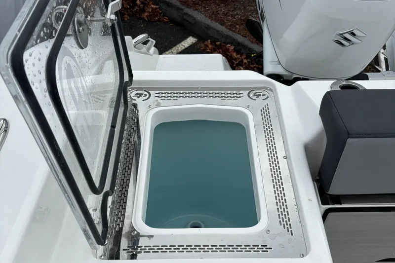 Slide: The Image of 2025 Sea Pro 292 DLX livewell with open lid, showcasing interior design. - 17