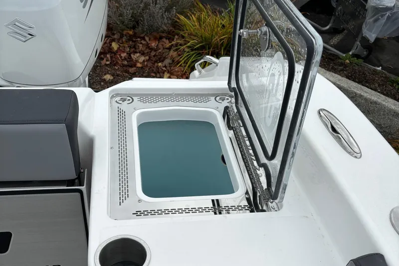 Slide: The Image of 2025 Sea Pro 292 DLX boat with open storage compartment and seating area. - 18