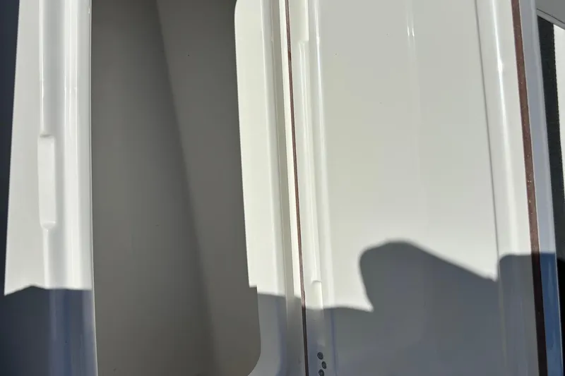 Slide: The Image of Close-up of 2025 Sea Pro 292 DLX boat's sleek white interior detail. - 21