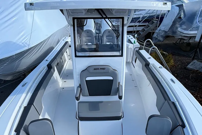 Slide: The Image of 2025 Sea Pro 292 DLX boat interior with seating and console. - 5