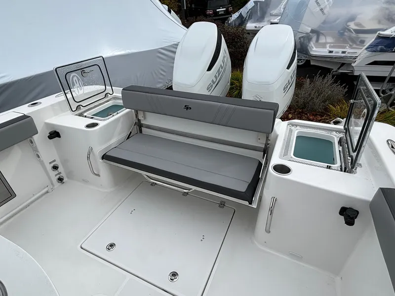 Slide: The Image of 2025 Sea Pro 292 DLX boat interior with seating and dual outboard engines. - 8