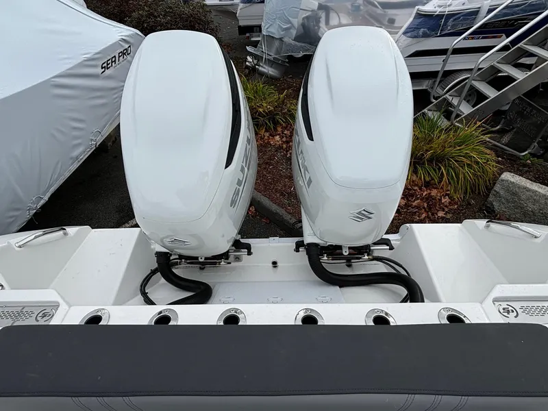 Slide: The Image of 2025 Sea Pro 292 DLX boat with dual outboard engines, rear view. - 9