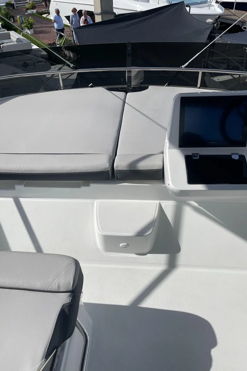 Slide: The Image of 2025 Jeanneau NC 1295 Coupe boat deck with seating and control panel. - 20
