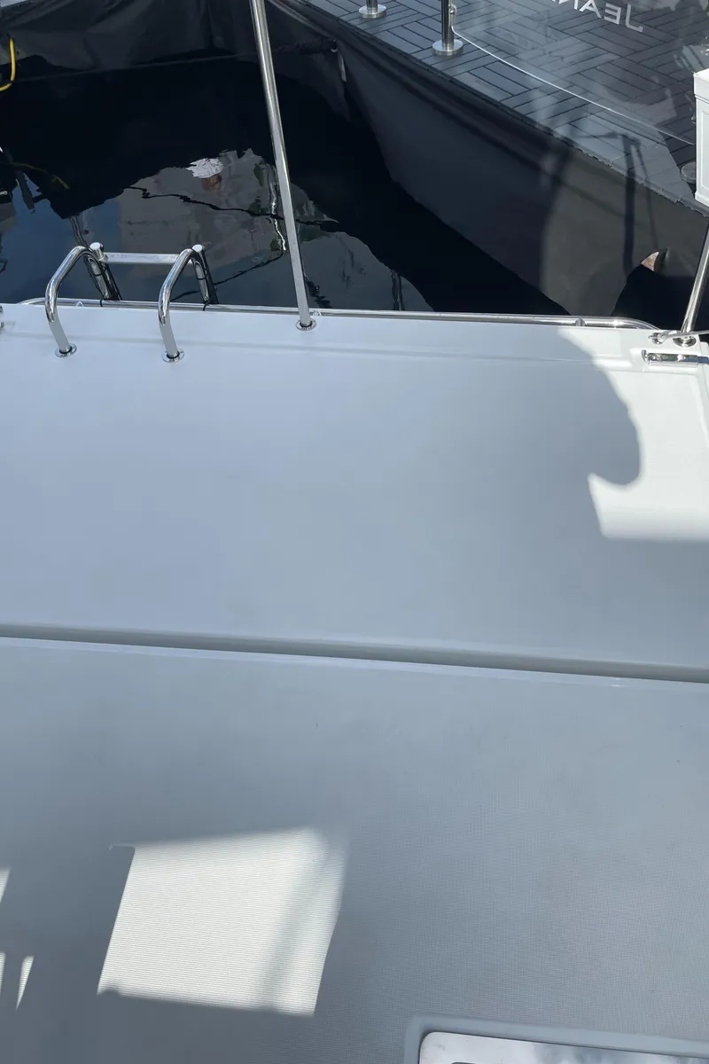Slide: The Image of 2025 Jeanneau NC 1295 Coupe boat deck with railing, docked at marina. - 21