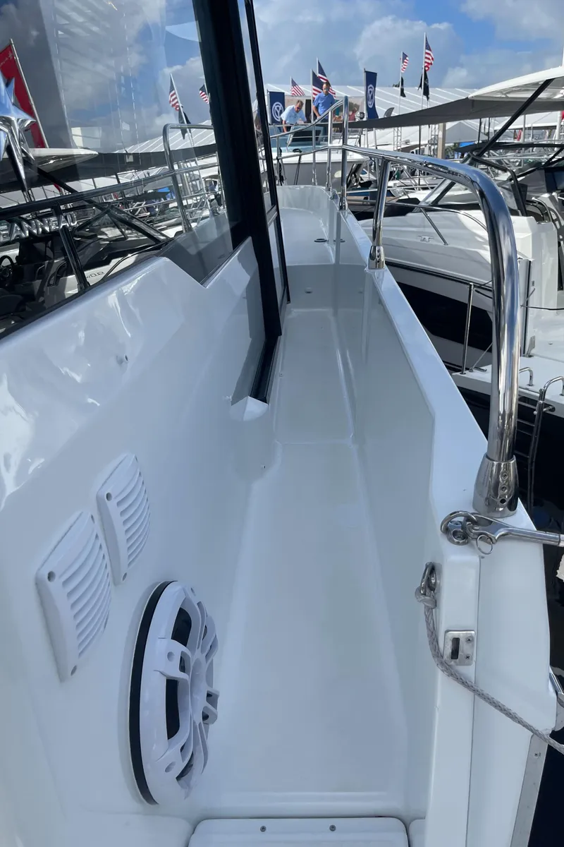 Slide: The Image of 2025 Jeanneau NC 1295 Coupe yacht deck with railing and speaker. - 22