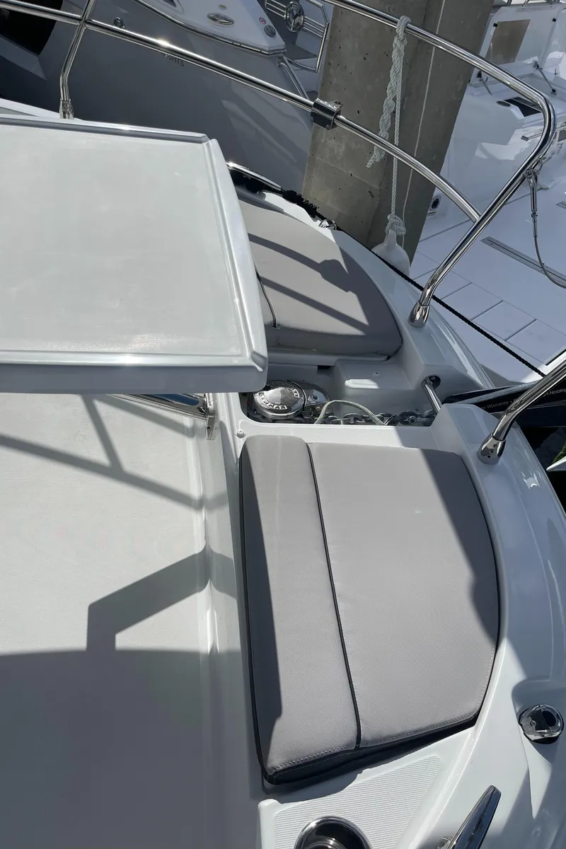 Slide: The Image of 2025 Jeanneau NC 1295 Coupe boat with cushioned seating and sleek design. - 24