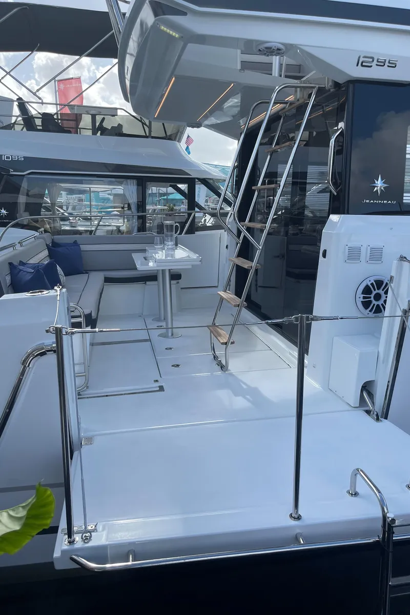 Slide: The Image of 2025 Jeanneau NC 1295 Coupe yacht with sleek deck and modern seating area. - 4