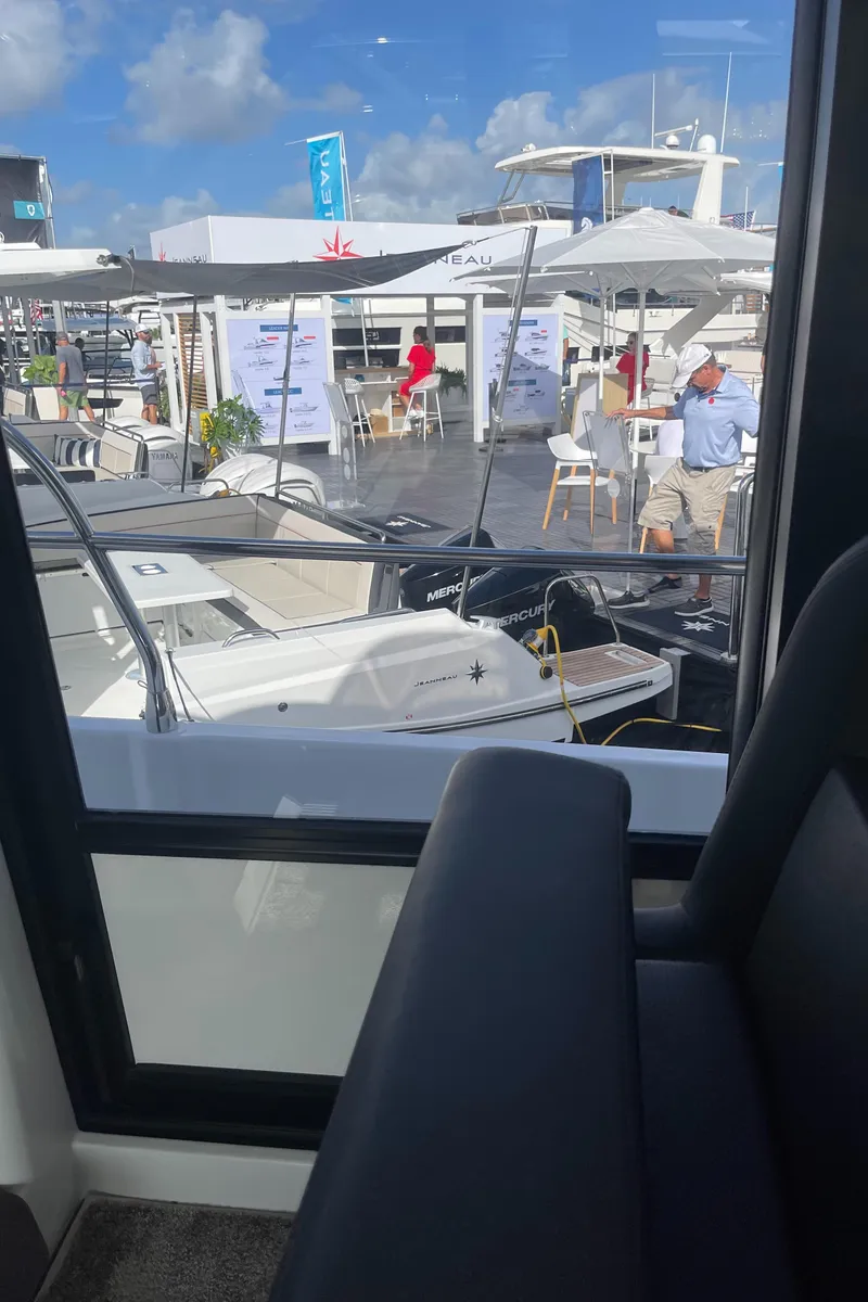 Slide: The Image of 2025 Jeanneau NC 1295 Coupe at a boat show, viewed from inside. - 11