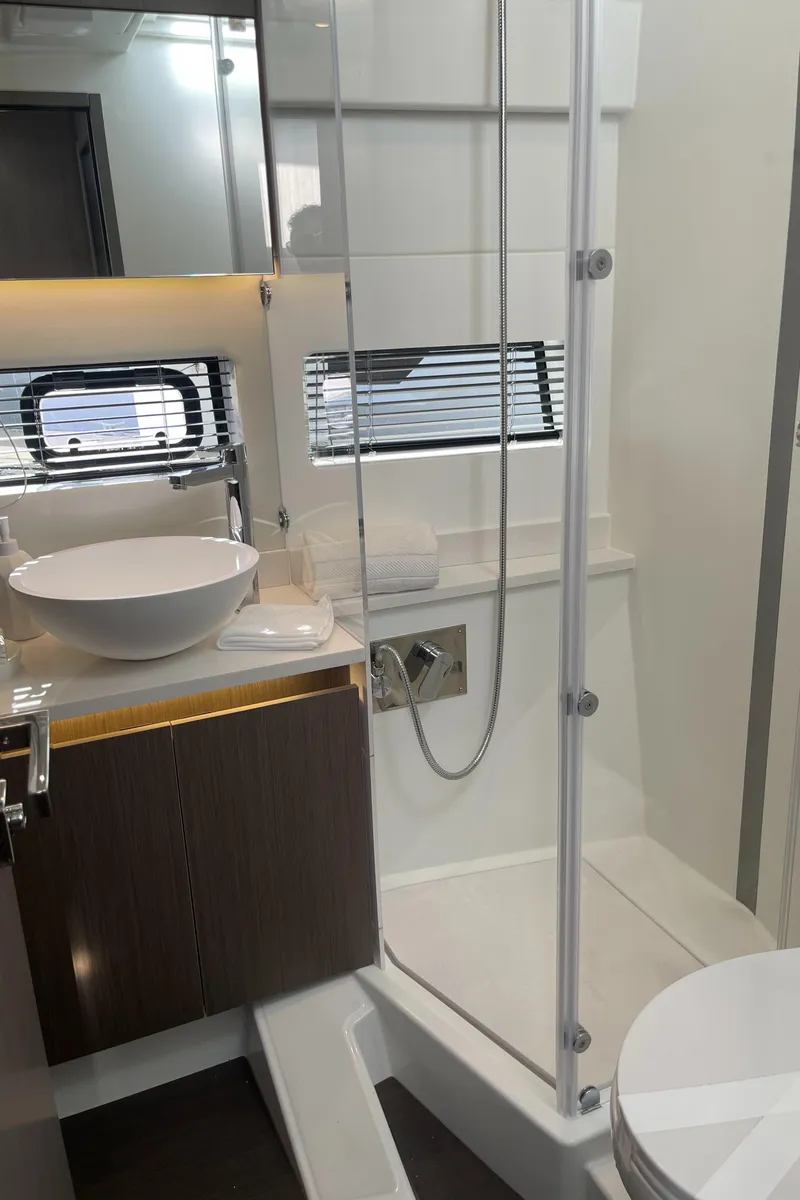 Slide: The Image of Modern bathroom in 2025 Jeanneau NC 1295 Coupe yacht with shower and sink. - 13