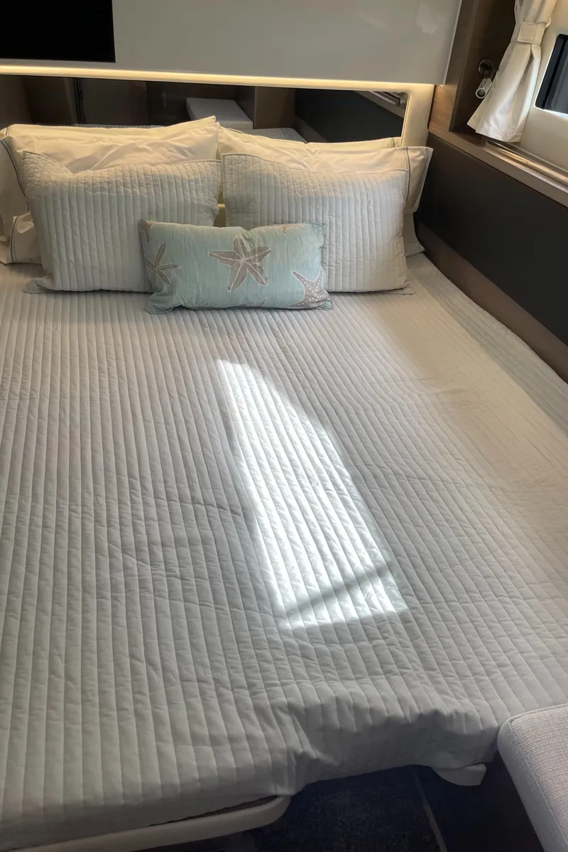 Slide: The Image of Luxurious bedroom interior of 2025 Jeanneau NC 1295 Coupe yacht. - 14