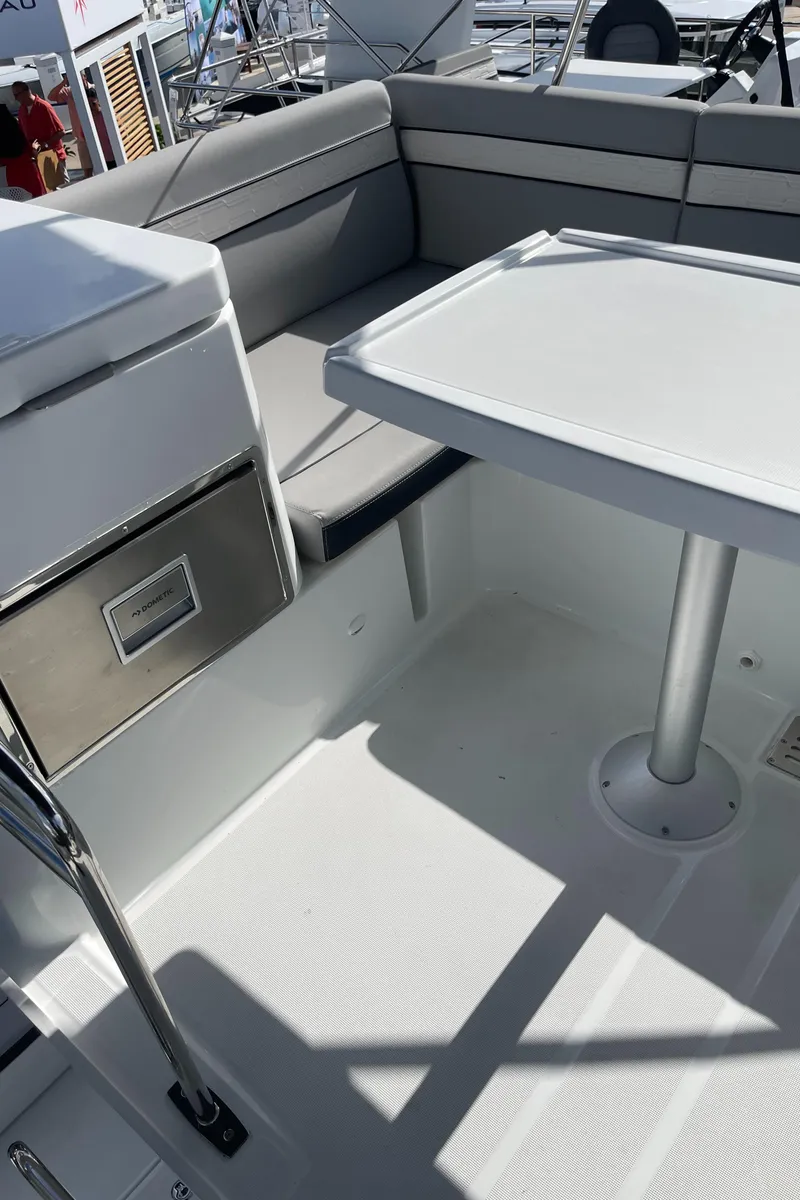 Slide: The Image of 2025 Jeanneau NC 1295 Coupe boat interior with seating and table. - 18