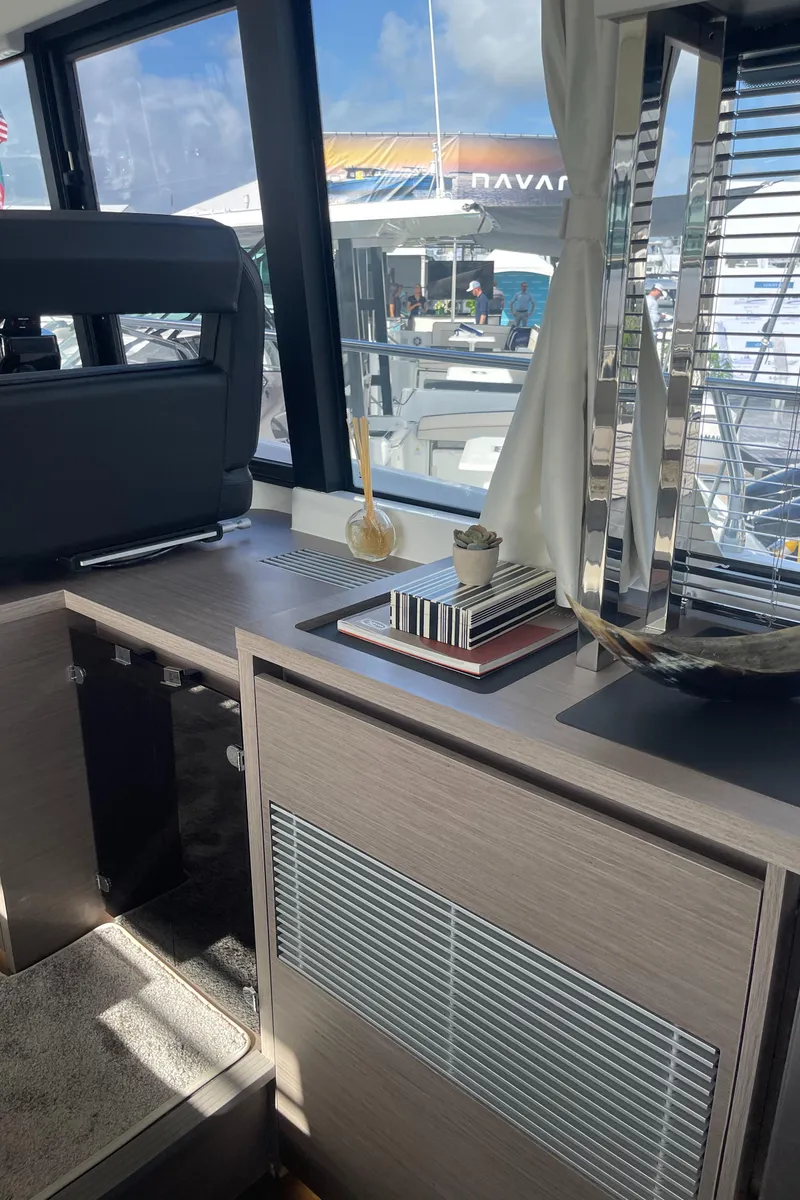 Slide: The Image of Interior of 2025 Jeanneau NC 1295 Coupe yacht with modern decor and large windows. - 8