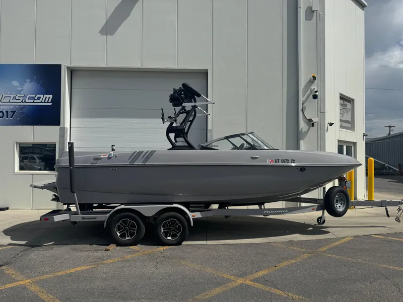 Slide: The Image of 2021 Moomba Craz boat on trailer outside a building. - 0
