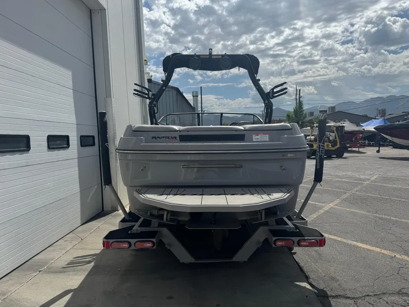 Slide: The Image of 2021 Moomba Craz boat parked outside a garage under a cloudy sky. - 4