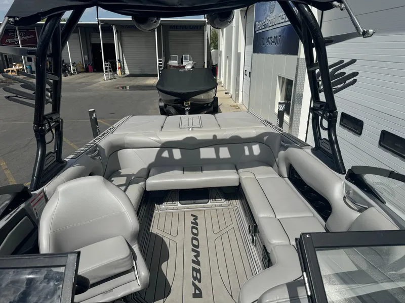 Slide: The Image of 2021 Moomba Craz boat interior with gray seating and open deck layout. - 7