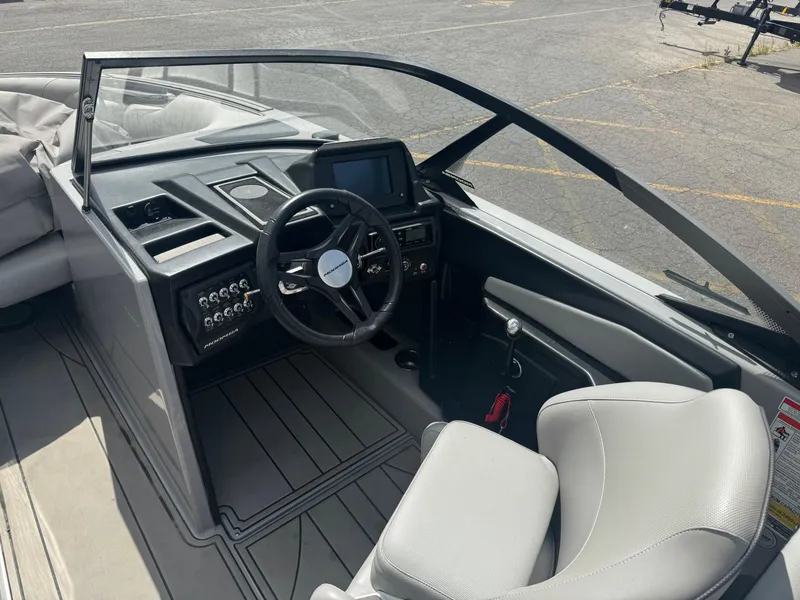 Slide: The Image of 2021 Moomba Craz boat interior with steering wheel and dashboard controls. - 8