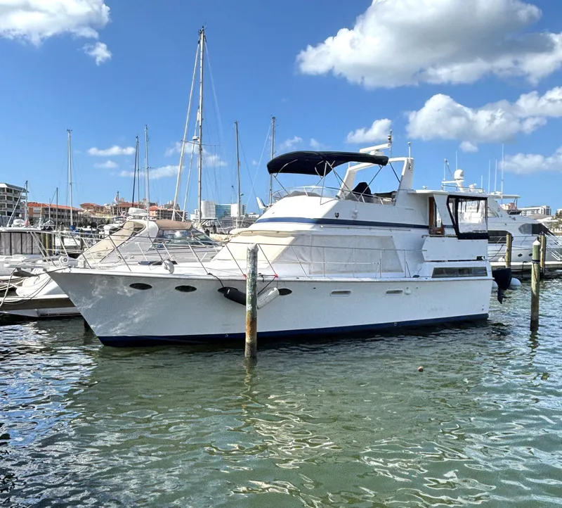 Slide: The Image of 1988 Marine Trader Tradewinds 43 Motor Yacht docked in sunny marina. - 0