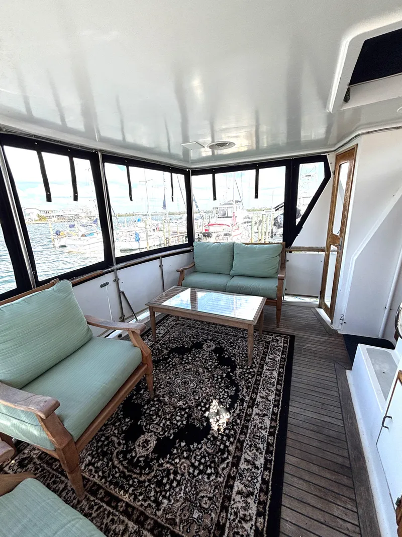 Slide: The Image of 1988 Marine Trader Tradewinds 43 Motor Yacht interior with seating and nautical decor. - 12