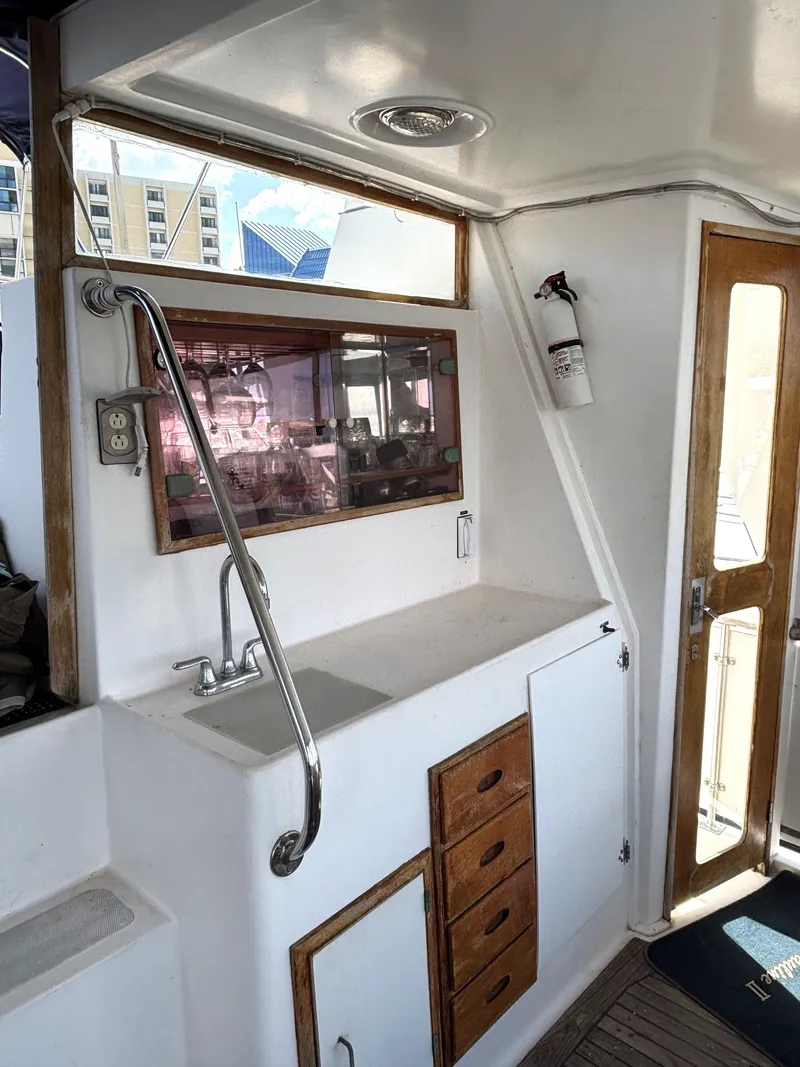 Slide: The Image of 1988 Marine Trader Tradewinds 43 Motor Yacht interior with sink and storage cabinets. - 13