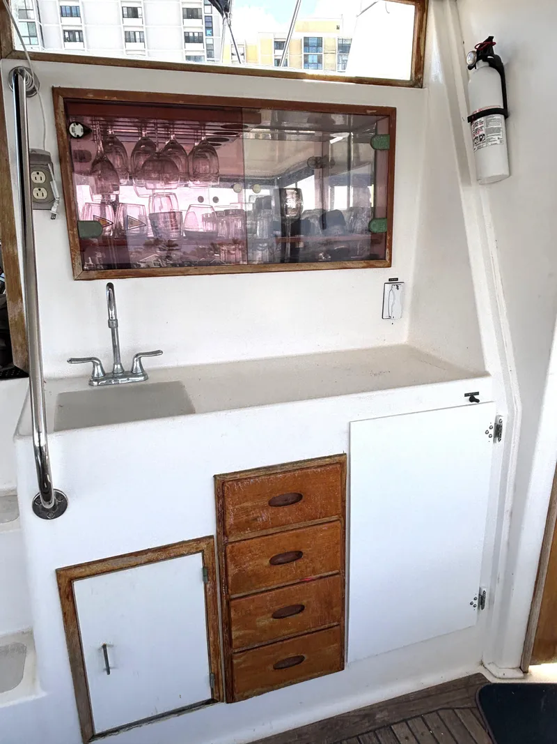 Slide: The Image of 1988 Marine Trader Tradewinds 43 Motor Yacht interior with sink and storage cabinets. - 14